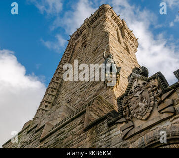 Looking up at Wallace Monument with carving detail and Willam Wallace statue, Stirling, Scotland, UK Stock Photo