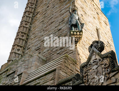 Looking up at Wallace Monument with carving detail and Willam Wallace statue, Stirling, Scotland, UK Stock Photo
