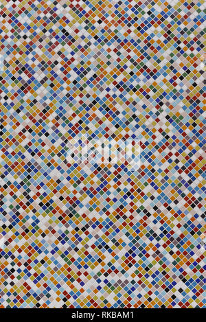 in the photo there is a background with a colorful mosaic of ceramic tiles. Mosaic of different colors, but each tile is the same shape and size Stock Photo