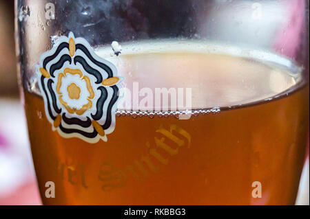 Close up view of a glass of Samuel Smith's Best Bitter in a pint glass showing the white rose of Yorkshire, Beverley, East Riding, Yorkshire, England Stock Photo