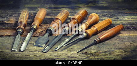 Old used wood chisels selection on the wooden table, Stock Photo