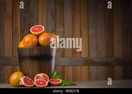 grapefruit basket still life on wooden background Stock Photo