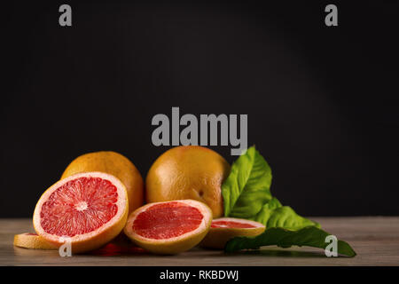 grapefruit on wooden table with black background Stock Photo