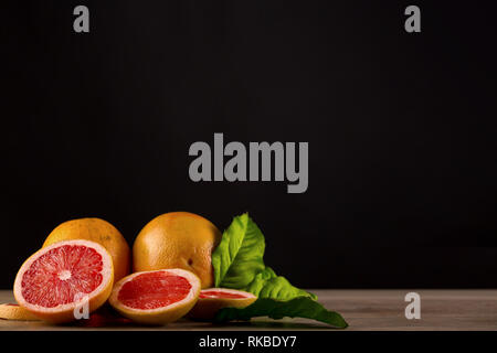 grapefruit on wooden table with black background Stock Photo