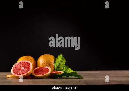 grapefruit on wooden table with black background Stock Photo