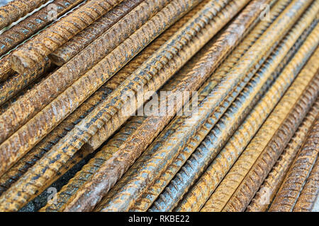 A lot of rusty reinforcement lies in the diagonal plane. Rusty iron texture Stock Photo