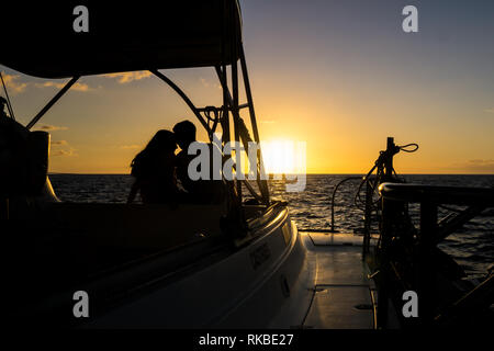 Moment along holding each other on a sunset cruise. Stock Photo