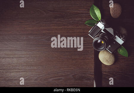 Photographers business card background. Zen photography background concept  with green leaves and sea stones on dark brown natural wooden background  Stock Photo - Alamy