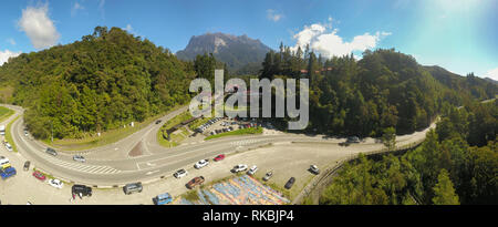 Panorama view of rocky mountain main entrance with green forest foreground. The Mount Kinabalu, the highest peak in Borneo Island. Stock Photo