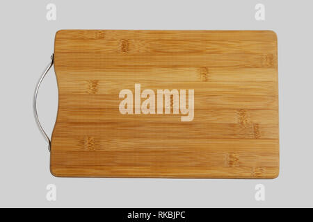 Wood chopping board. Close-up. Isolated on a gray background. Stock Photo