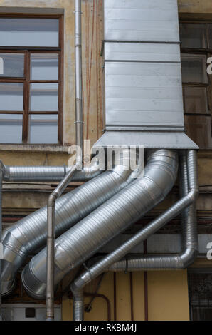 Ventilation and air conditioning system near to the window on the old house wall Stock Photo