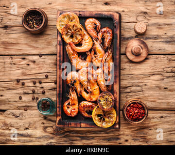 Roasted prawns on wooden cutting board.Grilled seafood Stock Photo