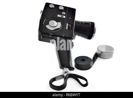 Vintage movie camera  with film charged on reels isolated on white background. History of film-making industry Stock Photo