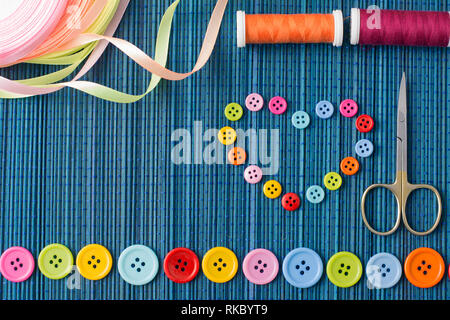 blue threads with buttons on the background of denim Stock Photo - Alamy