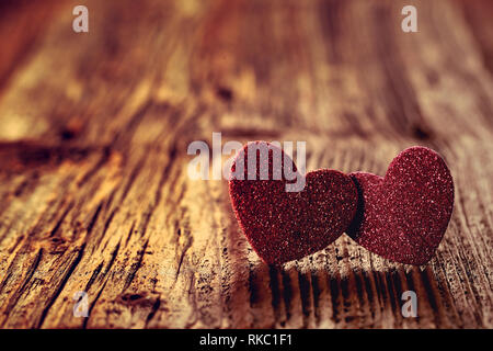 Two hearts on a wooden background on Valentines Day and empty space for text, close up vintage view Stock Photo