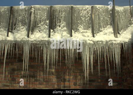 Icicles Dripping Off Of A Brick Building Stock Photo