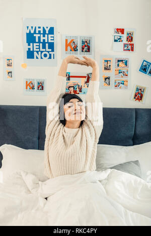 Young woman stretching while waking up in the morning Stock Photo