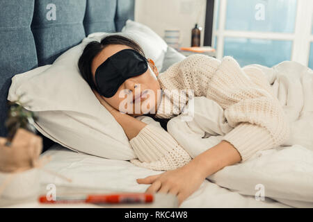 Young appealing woman sleeping at home after working day Stock Photo