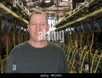 Kfar Vitkin, Israel. 22nd Jan, 2019. Farmer Peleg Orion stands in front of the milking station for his cows. Together with six other farmers, the Israeli has 700 dairy cows. On average, Israeli dairy cows produce the most milk worldwide. About 120 000 dairy cows live in Israel (to dpa 'Israel's miracle cows: strongest milk producers worldwide' of 11.02.2019) Credit: Stefanie Järkel/dpa/Alamy Live News Stock Photo