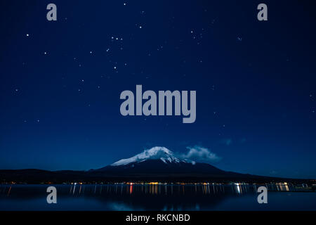 Nightview of Mount Fuji from Lake Yamanaka and Orion in winter. Stock Photo