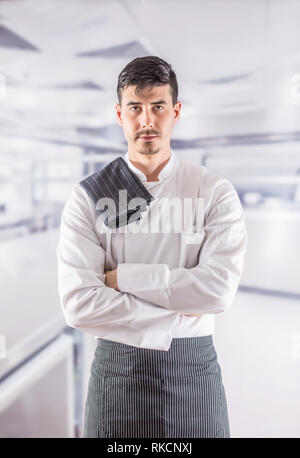 Chef professional in restaurant kitchen standing with towel on shoulder. Stock Photo