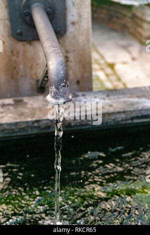 water runs out of a well Stock Photo