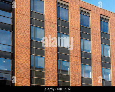 External elevation of modern red brick wall apartment Stock Photo