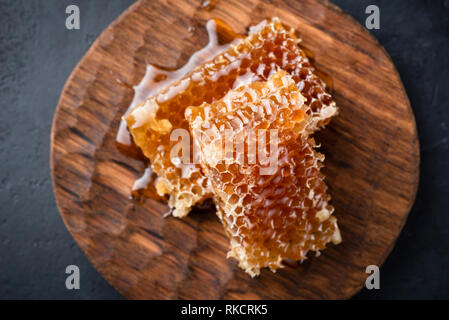 Honeycombs on wooden serving board. Top view selective focus Stock Photo