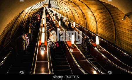 Moscow, Russa - February 22, 2015: Deep subway station is crowded with people riding the escalators down Stock Photo