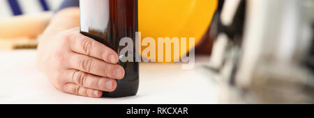 Arm of drunken worker in yellow helmet Stock Photo