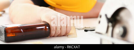 Arm of drunken worker in yellow helmet Stock Photo