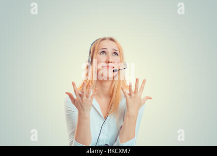 Woman with headset frustrated hands in air looking up Stock Photo