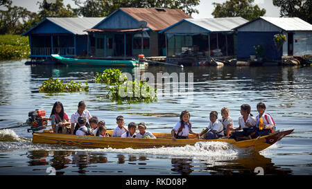 Tonlé Sap Lake,  Cambodia. 19th December, 2018. School children wearing uniforms in their floating village travel home from school in a motor boat. Ph Stock Photo