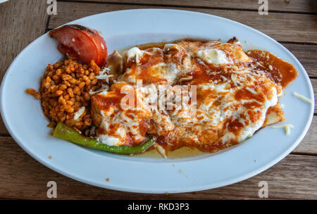 Turkish sarma beyti kebap with bulgur cereals and covered with yogurt. Stock Photo