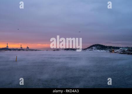 Beautiful and extremely cold morning in Oslo where the cold creates a mist reaction from the sea water. Stock Photo