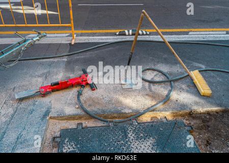 Red jackhammer at construction site. Stock Photo