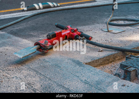 Red jackhammer at construction site. Stock Photo