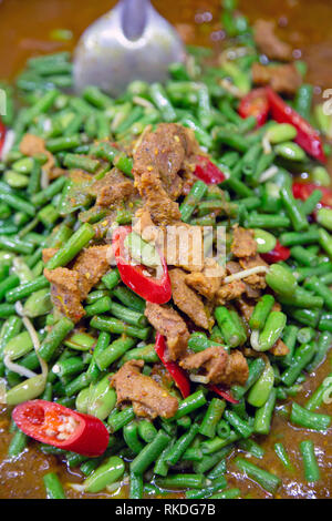 Pad prik king moo or stir fried pork with green bean is a type of Thai curry that is drier than other Thai curries such as red curry as it is fried in Stock Photo