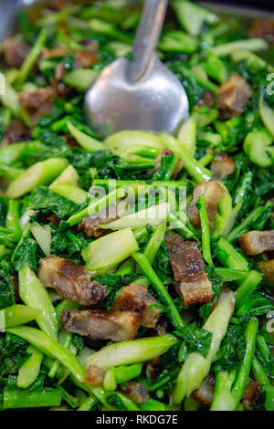 Pad pak kana moo krob literally translates to fried kale crispy pork in Thai. Crispy deep-fried pork belly stir fried in Oyster sauce with Chinese kal Stock Photo
