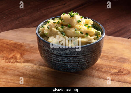 Pomme puree, a photo of a bowl of mashed potatoes with herbs on a rustic background with a place for text Stock Photo