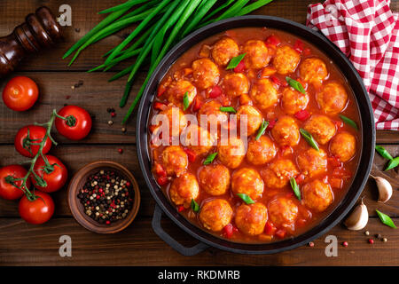 Chicken meatballs in spicy tomato sauce with vegetables in pan. Mexican cuisine Stock Photo