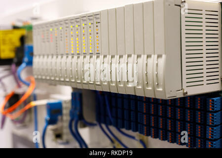 Programmable logic controller PLC modules installed in a rack. Selective focus. Stock Photo