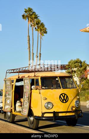 Classic 1960s yellow Volkswagon VW minibus camper van parked at Sunset ...