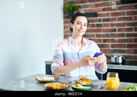 Smiling Woman Enjoying Breakfast Stock Photo