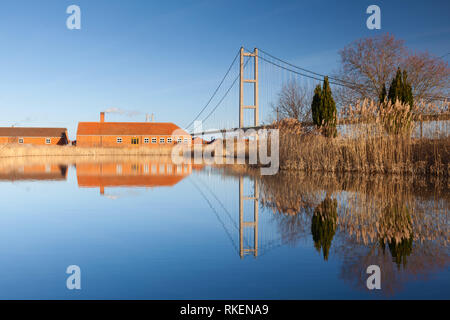 Barton-upon-Humber, Lincolnshire, UK. 11th Feb, 2019. UK Weather: A beautiful blue sky and reflections at The Old Tile Works and Humber Bridge. Barton-upon-Humber, North Lincolnshire, UK. 11th February 2019. Credit: LEE BEEL/Alamy Live News Stock Photo