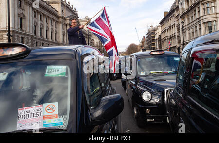 London, UK. 11th Feb, 2019. Licensed taxi Drivers block Parliament Square, Whitehall and surrounding streets. They have brought the area around Westminster to a standstill.They are protesting against the Mayor of London and TFL who have denied them access to Bank, Tottenham Court Road, Tooley Street, Greenwich, Lewisham, Islington and Hackney. They claim that the Mayor of London and TFL are engineering the destruction of the licensed Taxi trade through closing streets to them. Credit: Tommy London/Alamy Live News Stock Photo