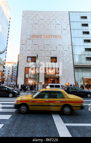 Tokyo, the Ginza, daytime. Louis Vuitton store building, illuminated window  displays, Christmas tree outside entrance and people walking by Stock Photo  - Alamy