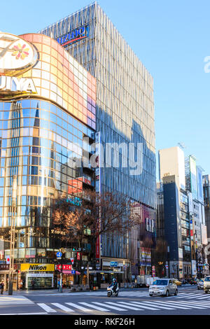 Tokyo, Ginza, golden hour. Flagship 4 level Gap store, largest in Japan, on Chuo Dori shopping street. Foreground, pedestrian crossing. Stock Photo