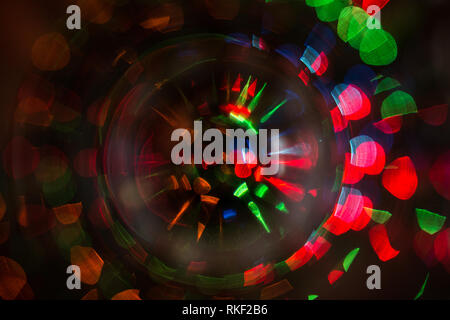 Abstract photo of blurry light sources of different colors twisted into a circle Stock Photo