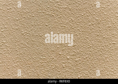 Bright beige rough plastered house wall frame as a background Stock Photo